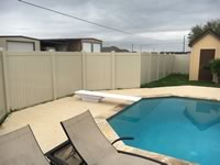 6 foot tall solid vinyl privacy fence enclosing a pool area
