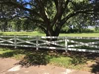 Ranch style vinyl fence made in a X configuration