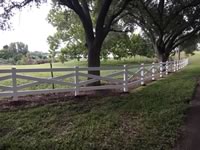 Ranch style vinyl fence made in a X configuration